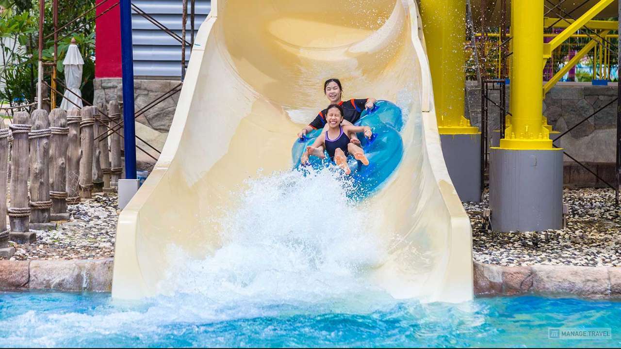 Teenagers enjoying their water slider ride at a water theme park in Phuket